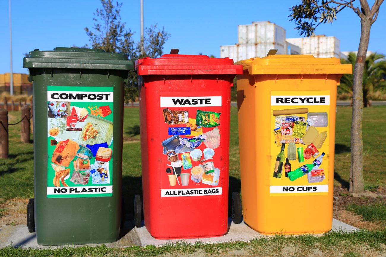 Three brightly colored waste bins placed where they can easily be found
